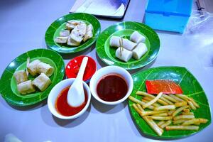 Boiled and fried dish with different sauces on the table photo