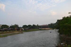 Scenic view of Namsong river by buildings against sky during twilights photo