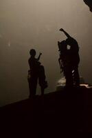 Silhouette of three people in Grubug vertical cave photo