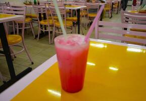 A glass of cold drink on the table photo