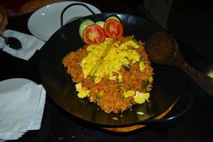 High angle view of fried rice in a frying pan on the table photo