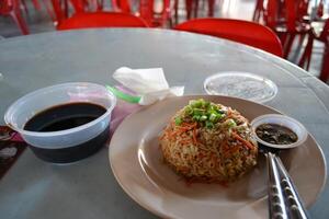 A plate of fried rice is served on the table photo
