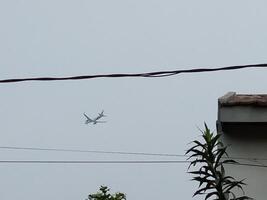 A low-flying plane approaches the airport photo