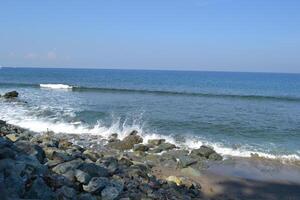 View of waves breaking on the beach photo