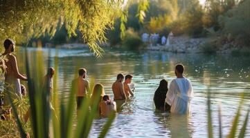 People being baptized in Jordan River in Israel in Baptist ceremony photo