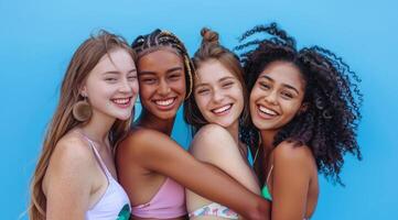 A group of pretty and attractive diverse young women are smiling for a photo in bikini