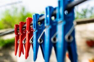 Three Red Clothespins on a Clothesline photo