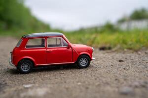 A close-up picture of a retro red toy car photo