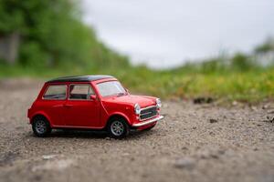 A close-up picture of a retro red toy car photo
