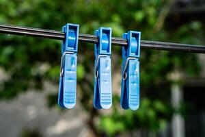 Three Red Clothespins on a Clothesline photo