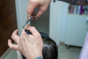 close up of a person cutting hair photo