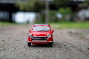 A close-up picture of a retro red toy car photo