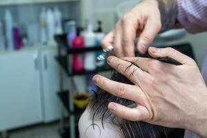 close up of a person cutting hair photo