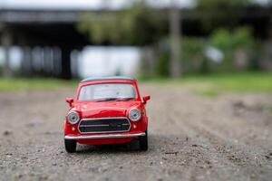 A close-up picture of a retro red toy car photo