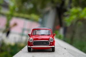 A close-up picture of a retro red toy car photo