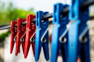 Three Red Clothespins on a Clothesline photo