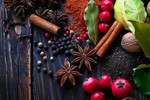 Various oriental herb like star anise, black pepper, cinnamon, bay leaf on wooden table photo