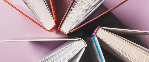 Open books on a pink background. Mock up with education and reading concept. Literature for learning, development and joy photo