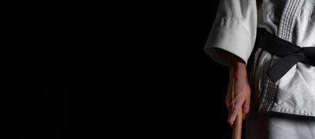 A person practicing aikido on a black background. photo