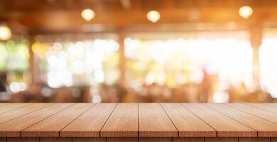 Empty wooden table top with lights bokeh on blur restaurant background. photo