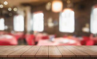 Empty wooden table top with lights bokeh on blur restaurant background photo