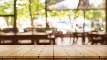 Empty wooden table top with lights bokeh on blur restaurant background. photo