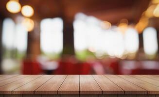 Empty wooden table top with lights bokeh on blur restaurant background photo