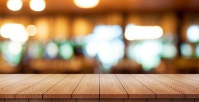 Empty wooden table top with lights bokeh on blur restaurant background. photo