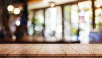 Empty wooden table top with lights bokeh on blur restaurant background. photo