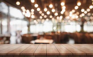 Empty wooden table top with lights bokeh on blur restaurant background photo