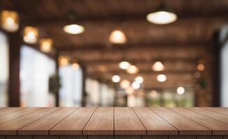 Empty wooden table top with lights bokeh on blur restaurant background photo