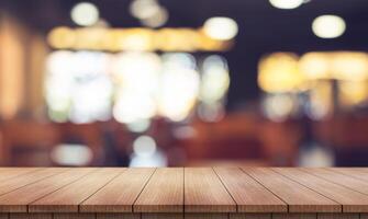 Empty wooden table top with lights bokeh on blur restaurant background. photo