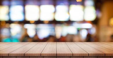 Empty wooden table top with lights bokeh on blur restaurant background. photo