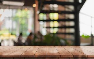 Empty wooden table top with lights bokeh on blur restaurant background. photo