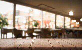 Empty wooden table top with lights bokeh on blur restaurant background photo