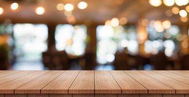 Empty wooden table top with lights bokeh on blur restaurant background. photo