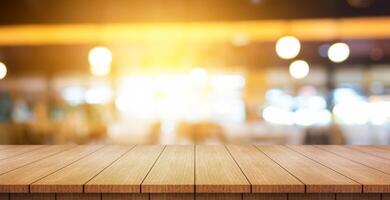 Empty wooden table top with lights bokeh on blur restaurant background. photo