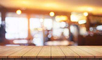 Empty wooden table top with lights bokeh on blur restaurant background. photo