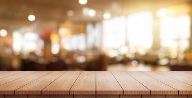 Empty wooden table top with lights bokeh on blur restaurant background. photo