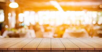 Empty wooden table top with lights bokeh on blur restaurant background. photo