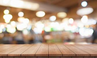 Empty wooden table top with lights bokeh on blur restaurant background. photo