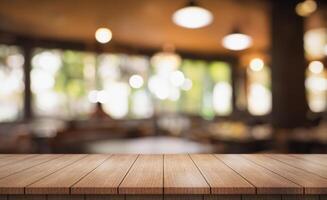 Empty wooden table top with lights bokeh on blur restaurant background photo