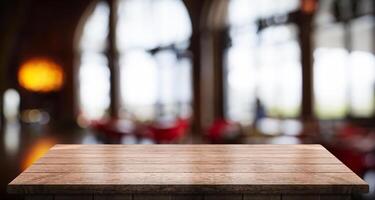 Empty wooden table top with lights bokeh on blur restaurant background photo