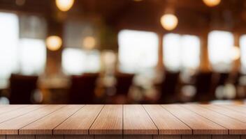 Empty wooden table top with lights bokeh on blur restaurant background. photo