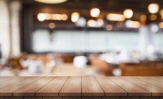 Empty wooden table top with lights bokeh on blur restaurant background photo