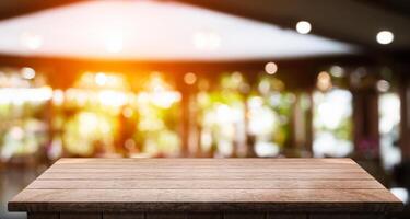 Empty wooden table top with lights bokeh on blur restaurant background photo