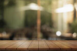 Empty wooden table top with lights bokeh on blur restaurant background. photo