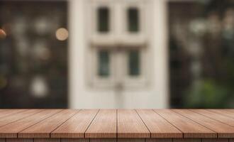 Empty wooden table top with lights bokeh on blur restaurant background. photo