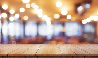 Empty wooden table top with lights bokeh on blur restaurant background. photo