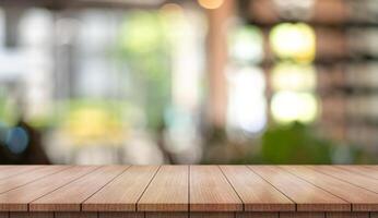 Empty wooden table top with lights bokeh on blur restaurant background. photo